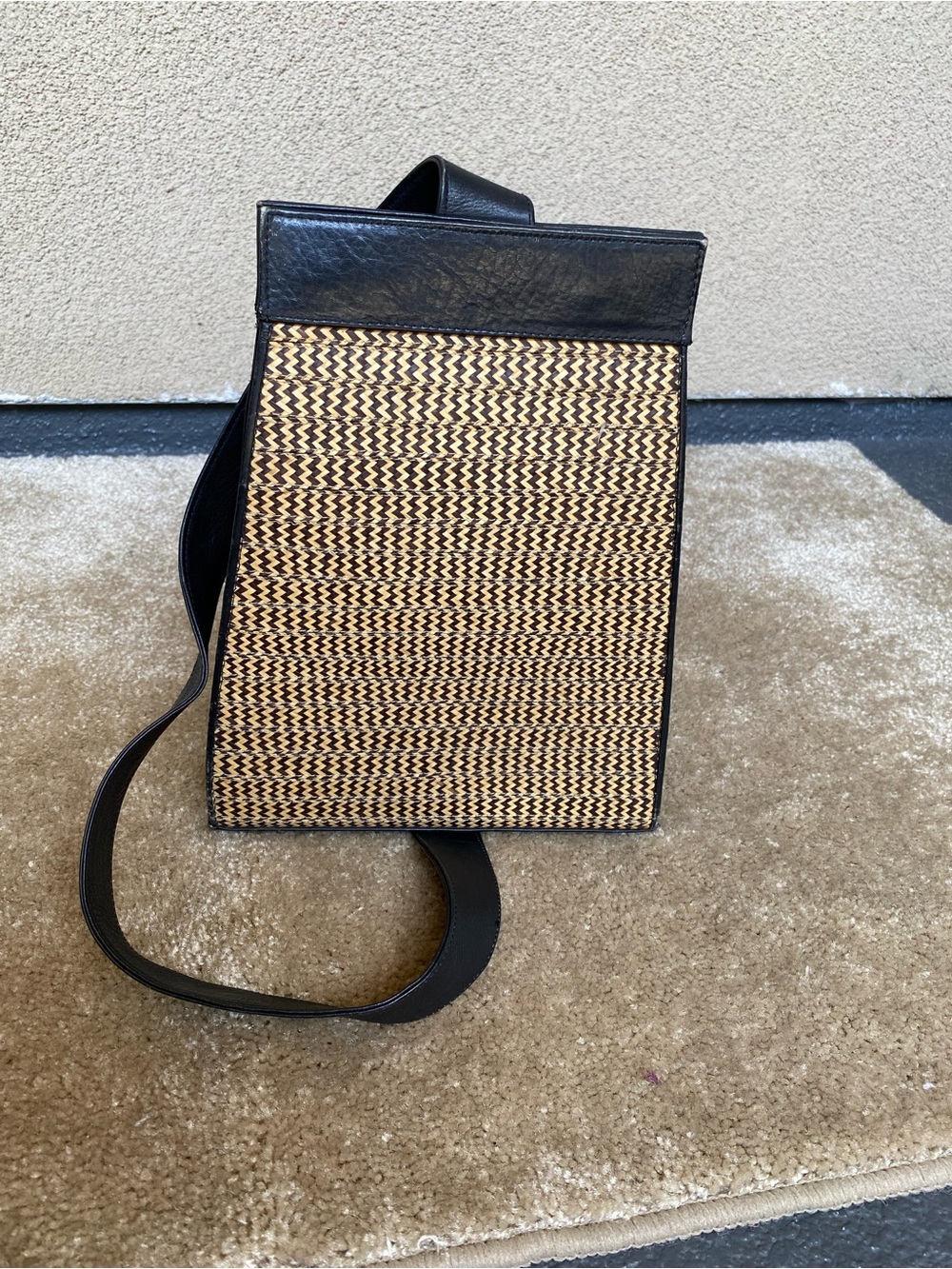 Vintage woven straw and black leather shoulder bag with a geometric herrin